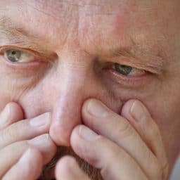 A man suffers from a stuffy nose.