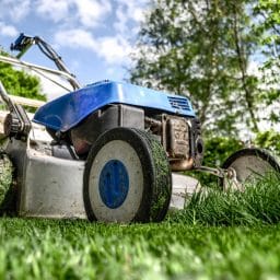 Close up of a lawnmower mowing a lawn