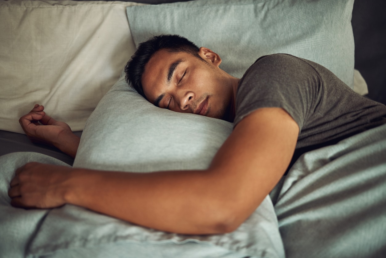 Young man sleeping in bed.