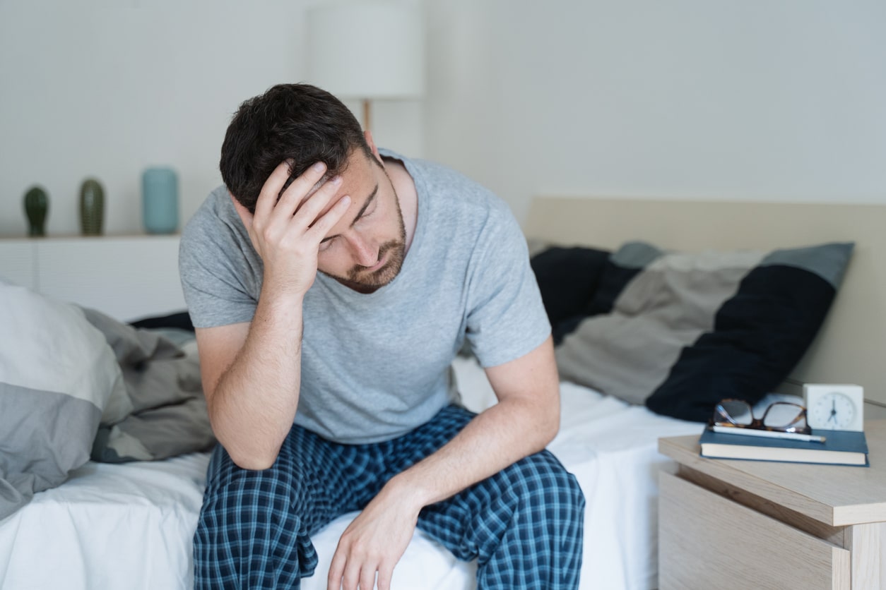Tired man holding his forehead.
