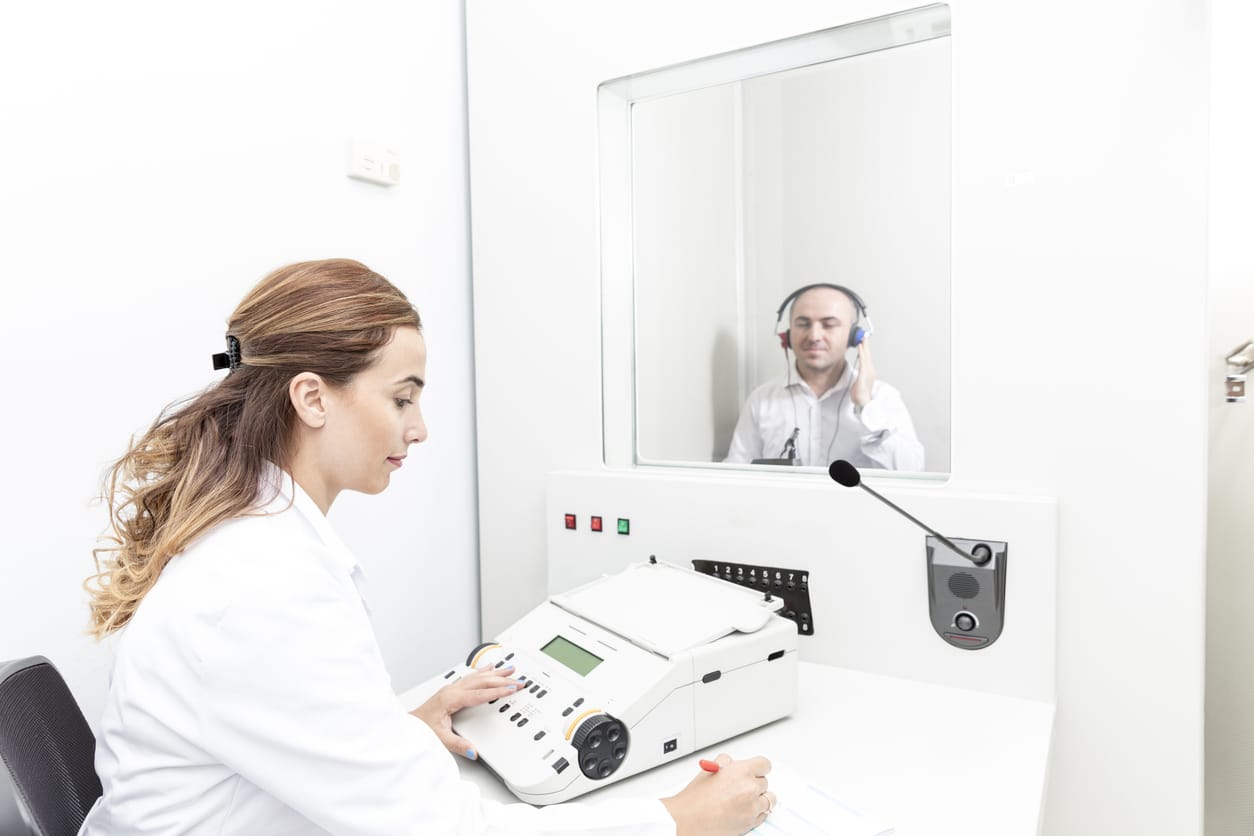Doctor administering a hearing test.