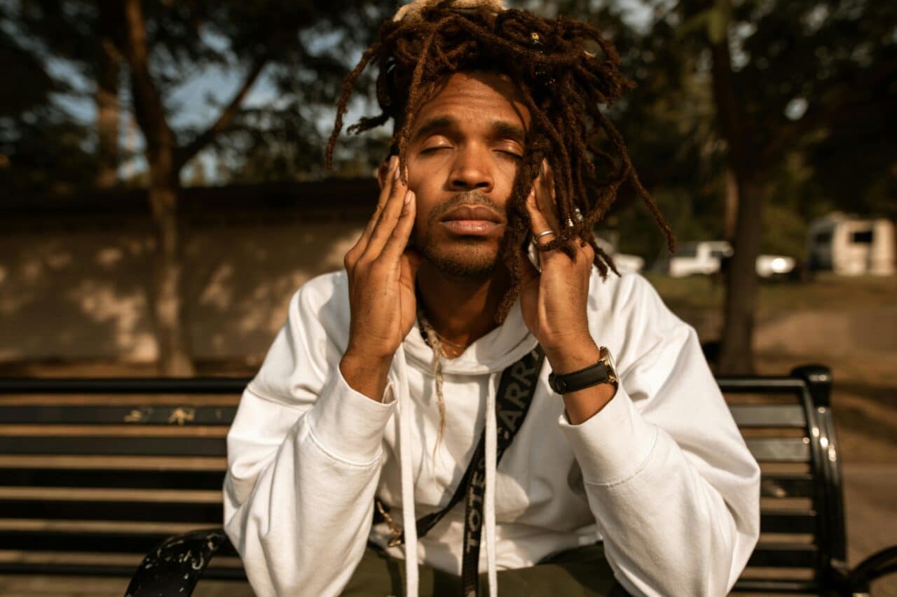 Man with seasonal allergies experiencing a headache.