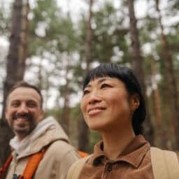 Smiling couple on a hike in the woods