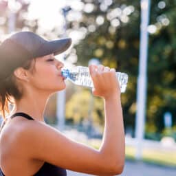Drinking fresh water on a hot day to stay hydrated