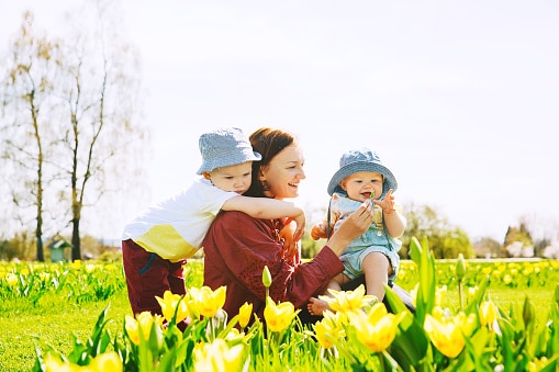 Happy family playing in the public garden
